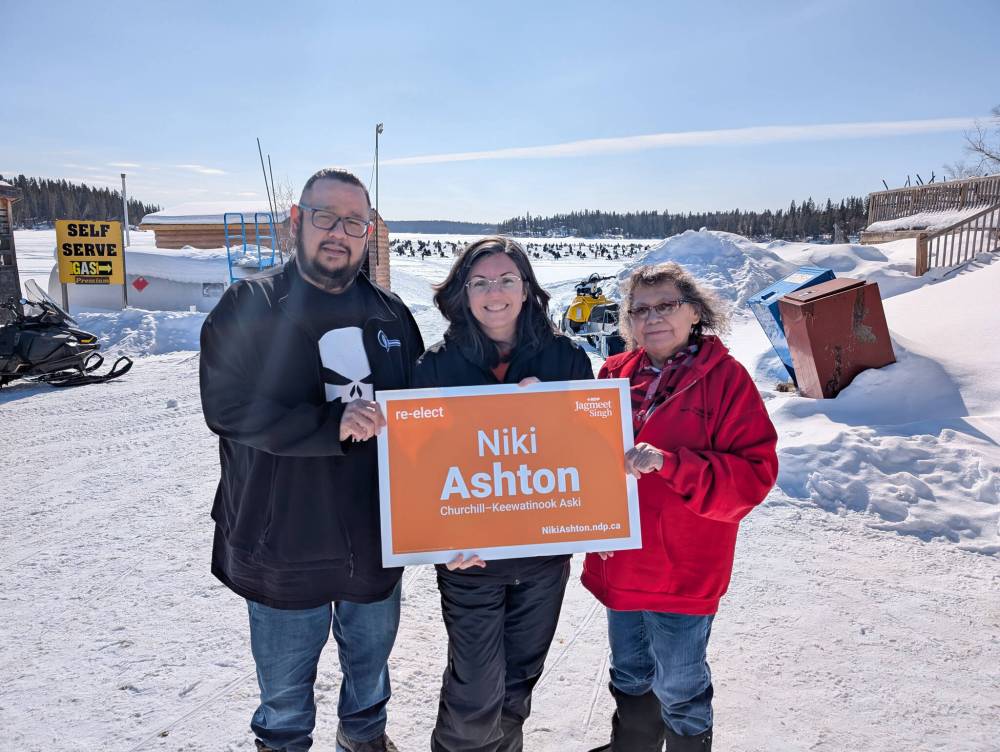 COURTESY OF NIKI ASHTON
Incumbent NDP MP, Niki Ashton, holds a campaign sign with two of her constituents at a fishing derby on Paint Lake, near Thompson.