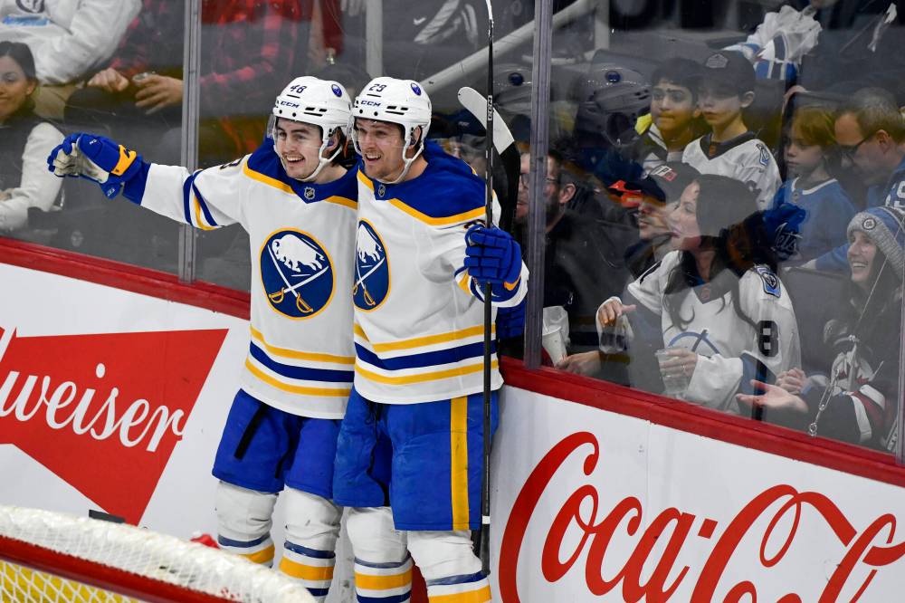 Fred Greenslade / THE CANADIAN PRESS
Buffalo Sabres’ Tyson Kozak (left) celebrates his goal against the Winnipeg Jets on Sunday. It was Kozak’s second career NHL goal.