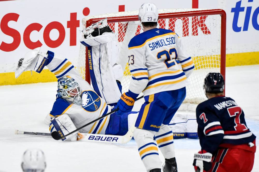 Fred Greenslade / THE CANADIAN PRESS
Buffalo Sabres’ goaltender James Reimer (left) makes a save on in the third period on Sunday. Reimer kept Buffalo in the game, despite the Sabres being outshot 36-17.