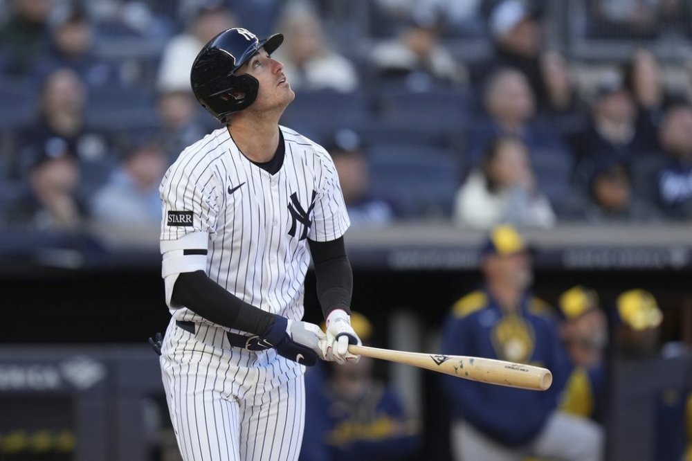New York Yankees' Paul Goldschmidt looks up at his sacrifice fly during the seventh inning of a baseball game against the Milwaukee Brewers at Yankee Stadium, Thursday, March 27, 2025, in New York. (AP Photo/Seth Wenig)