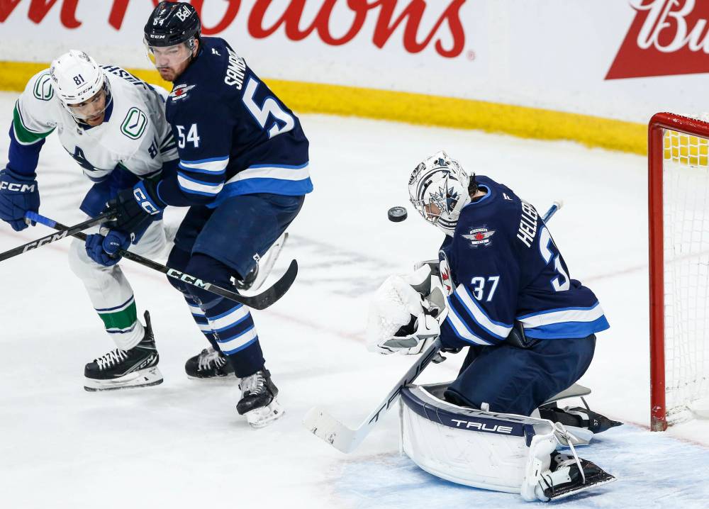 John Woods / THE CANADIAN PRESS
Winnipeg Jets goaltender Connor Hellebuyck (left) saves the shot from during third period NHL action at Canada Life Centre on Sunday.