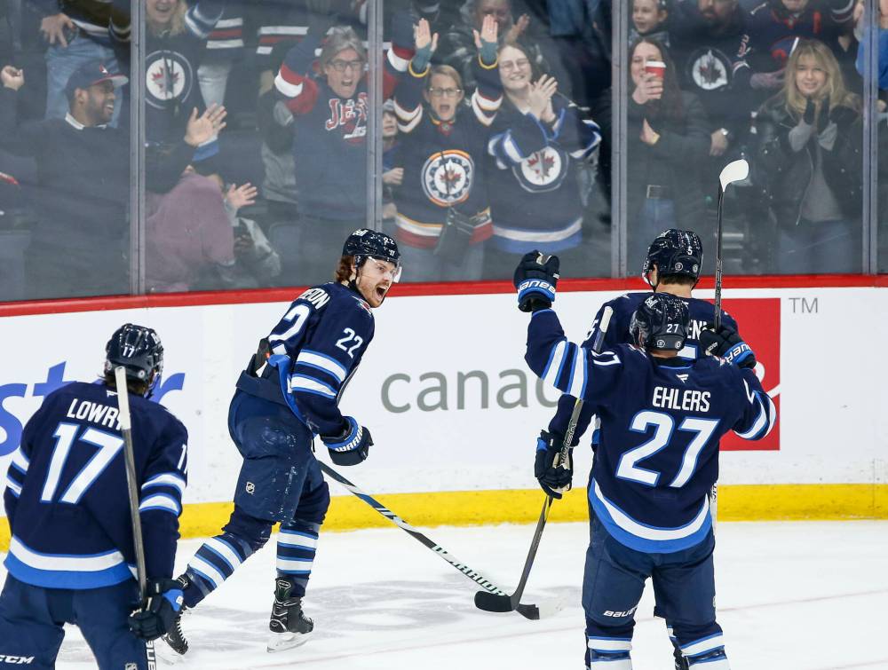 John Woods / THE CANADIAN PRESS
From left: Winnipeg Jets’ Adam Lowry, Mason Appleton, Nikolaj Ehlers and Luke Schenn celebrate Appleton’s game-winning goal against the Vancouver Canucks Sunday.