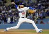 Los Angeles Dodgers' Dustin May throws against the Atlanta Braves during the first inning of a baseball game Tuesday, April 1, 2025, in Los Angeles. (AP Photo/Kevork Djansezian)