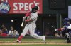 Boston Red Sox's Wilyer Abreu connects for a three-run homerun as Texas Rangers' Kyle Higashioka, right, looks on in the ninth inning of an opening-day baseball game, Thursday, March 27, 2025, in Arlington, Texas. (AP Photo/Tony Gutierrez)
