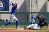 Toronto Blue Jays second baseman Andres Gimenez, left, completes a double play after forcing out Detroit Tigers' Kerry Carpenter in the second inning of a spring training baseball game, Monday, March 3, 2025, in Lakeland, Fla. (AP Photo/John Raoux)