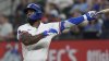 Texas Rangers' Adolis García follows through on a swing during an at-bat in the fourth inning of a baseball game against the Boston Red Sox, Saturday, March 29, 2025, in Arlington, Texas. (AP Photo/LM Otero)