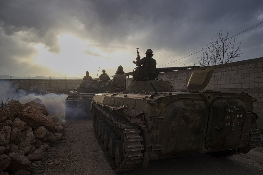 Syrian troops maneuver in the village of Hawsh al-Sayyid Ali, located 2 km (1.24 miles) from the Lebanon border, Syria, Monday, March 17, 2025. Lebanon's president ordered troops to retaliate for gunfire from the Syrian side of the border after renewed fighting broke out overnight along the frontier. (AP Photo/Omar Albam)