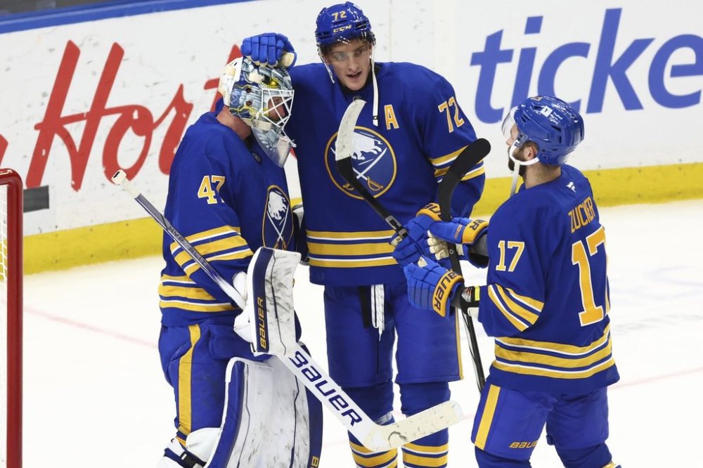 Buffalo Sabres goaltender James Reimer (47) celebrates a victory with center Tage Thompson (72) and left wing Jason Zucker (17) after an NHL hockey game against the Ottawa Senators, Tuesday, March 25, 2025, in Buffalo, N.Y. (AP Photo/Jeffrey T. Barnes)