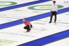 Canada skip Brad Jacobs watches his stone as China's Zhiyu Wang looks on during the bronze-medal game at the BKT World Men's Curling Championship in Moose Jaw, Sask., on Sunday, April 6, 2025. THE CANADIAN PRESS/Chris Young