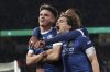 Bielefeld's Maximilian Gro'er, left, celebrates scoring their side's second goal of the game with Bielefeld's Ma'l Corboz during the German soccer cup, DFB Pokal, semi-final soccer match between Arminia Bielefeld and Bayer Leverkusen in Bielefeld, Germany, Tuesday, April 1, 2025. (Friso Gentsch/dpa via AP)