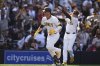 San Diego Padres' Gavin Sheets, left, celebrates his home run with third base coach Tim Leiper during the seventh inning of an opening-day baseball game against the Atlanta Braves, Thursday, March 27, 2025, in San Diego. (AP Photo/Gregory Bull)