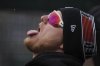 Detroit Tigers' Parker Meadows tries catching snow flakes in the dugout in the fourth inning during a baseball game against the New York Yankees, Monday, April 7, 2025, in Detroit. (AP Photo/Paul Sancya)