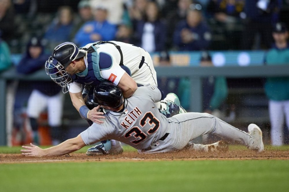 Detroit Tigers' Colt Keith is forced out at home by Seattle Mariners catcher Mitch Garver on a bases loaded hit during the ninth inning in a baseball game, Wednesday, April 2, 2025, in Seattle. (AP Photo/John Froschauer)