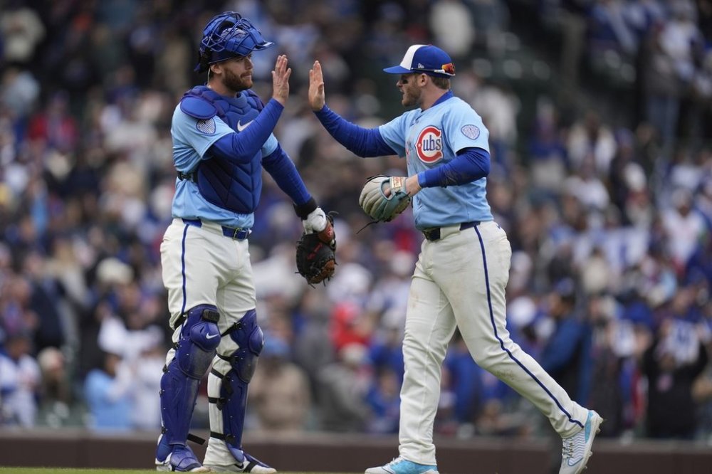 Chicago Cubs catcher Carson Kelly (15), left, and Ian Happ celebrate their team's win over the San Diego Padres in a baseball game Saturday, April 5, 2025, in Chicago. (AP Photo/Erin Hooley)