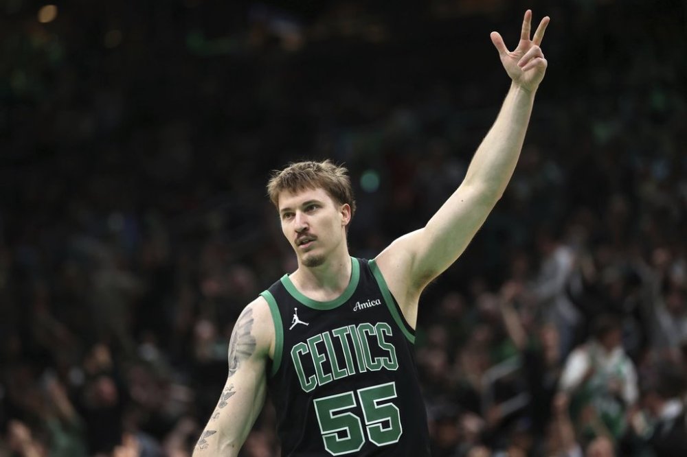 Boston Celtics' Baylor Scheierman celebrates his 3-pointer during second half of an NBA basketball game against the Brooklyn Nets Tuesday, March 18, 2025, in Boston. (AP Photo/Michael Dwyer)