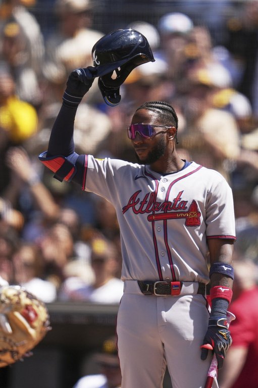 Atlanta Braves' Jurickson Profar acknowledges the crowd as he walks up to bat during the first inning of an opening-day baseball game against his former team, the San Diego Padres, Thursday, March 27, 2025, in San Diego. (AP Photo/Gregory Bull)