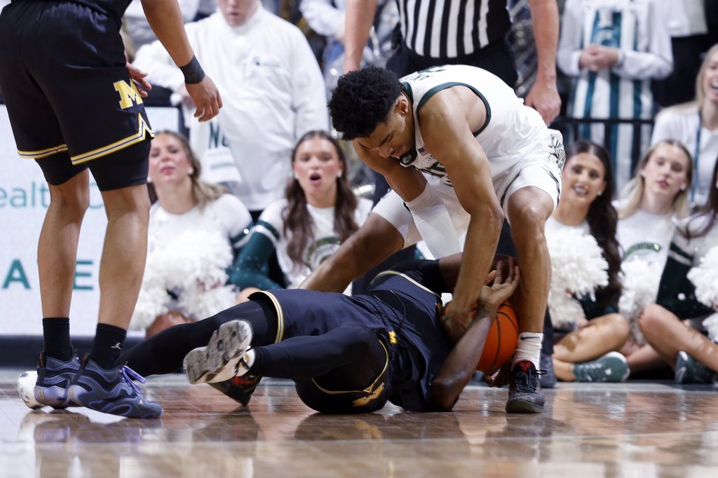 Bitter rivals: Michigan and Michigan State players shove one another at ...