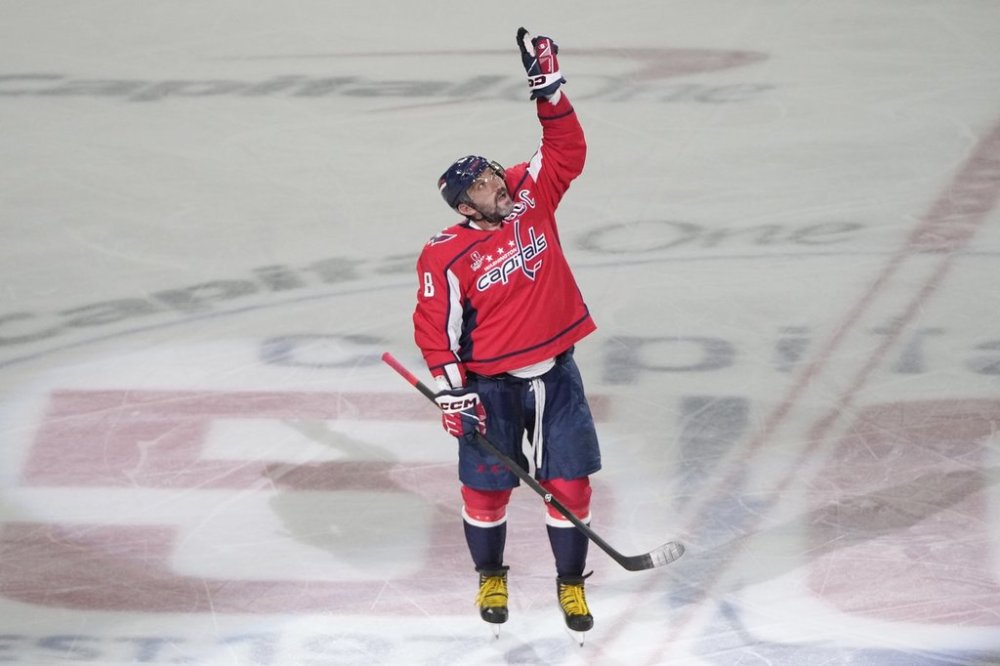 Washington Capitals left wing Alex Ovechkin (8) pointing upwards after scoring his 894th goal against the Chicago Blackhawks during the third period of an NHL hockey game Friday, April 4, 2025, in Washington. (AP Photo/Mark Schiefelbein)