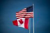 Canadian and U.S. flags fly atop the Peace Arch monument at the Douglas-Peace Arch border crossing in Surrey, B.C., on Monday, Nov. 8, 2021. THE CANADIAN PRESS/Darryl Dyck