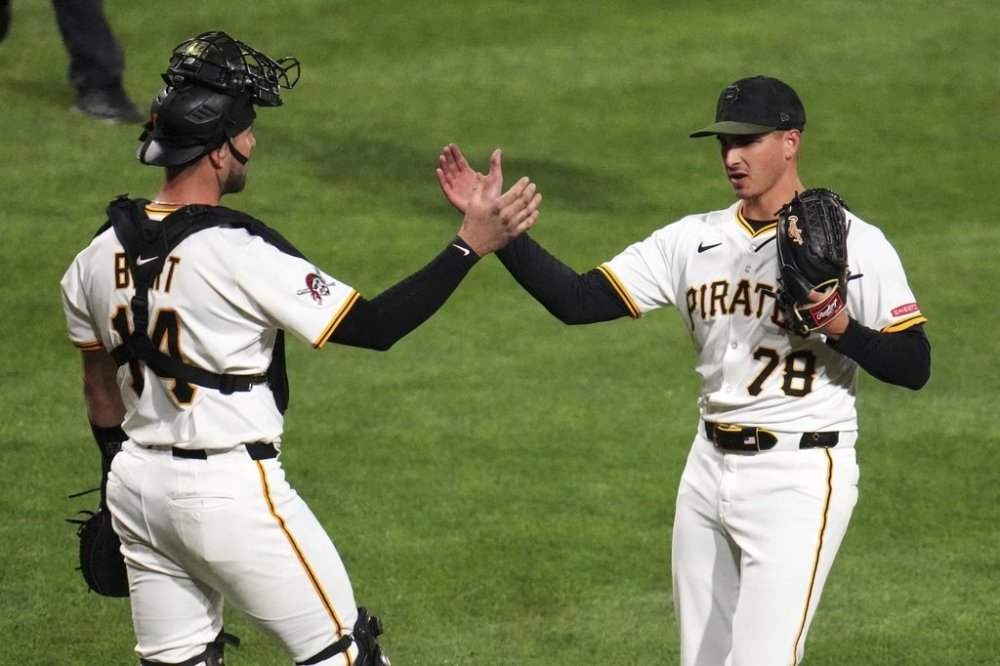 Pittsburgh Pirates pitcher Thomas Harrington (78) celebrates with catcher Joey Bart, left, after getting the final out of a baseball game against the St. Louis Cardinals in Pittsburgh, Monday, April 7, 2025. (AP Photo/Gene J. Puskar)
