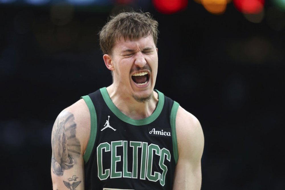 Boston Celtics' Baylor Scheierman reacts after making a 3-pointer during second half of an NBA basketball game against the Brooklyn Nets Tuesday, March 18, 2025, in Boston. (AP Photo/Michael Dwyer)