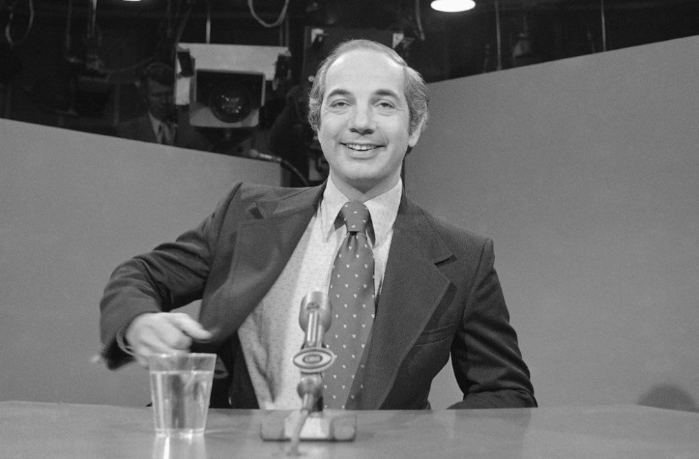FILE - White House press secretary Ron Nessen talks with reporters prior to an appearance on separate television interview programs, March 24, 1975, in Washington. Nessen, a veteran broadcast journalist who served as Ford's press secretary, died March 12, 2025. He was 90. (AP Photo/John Duricka)