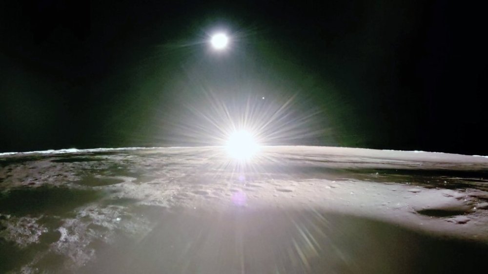 This image provided by NASA/Firefly Aerospace, Tuesday, March 18, 2025, shows the sun setting on the moon, with Earth and Venus in the distance. (NASA/Firefly Aerospace via AP)