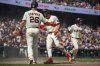 San Francisco Giants' Willy Adames celebrates with Patrick Bailey after scoring during the fourth inning of a baseball game against the Seattle Mariners in San Francisco, Friday, April 4, 2025. (AP Photo/Nic Coury)