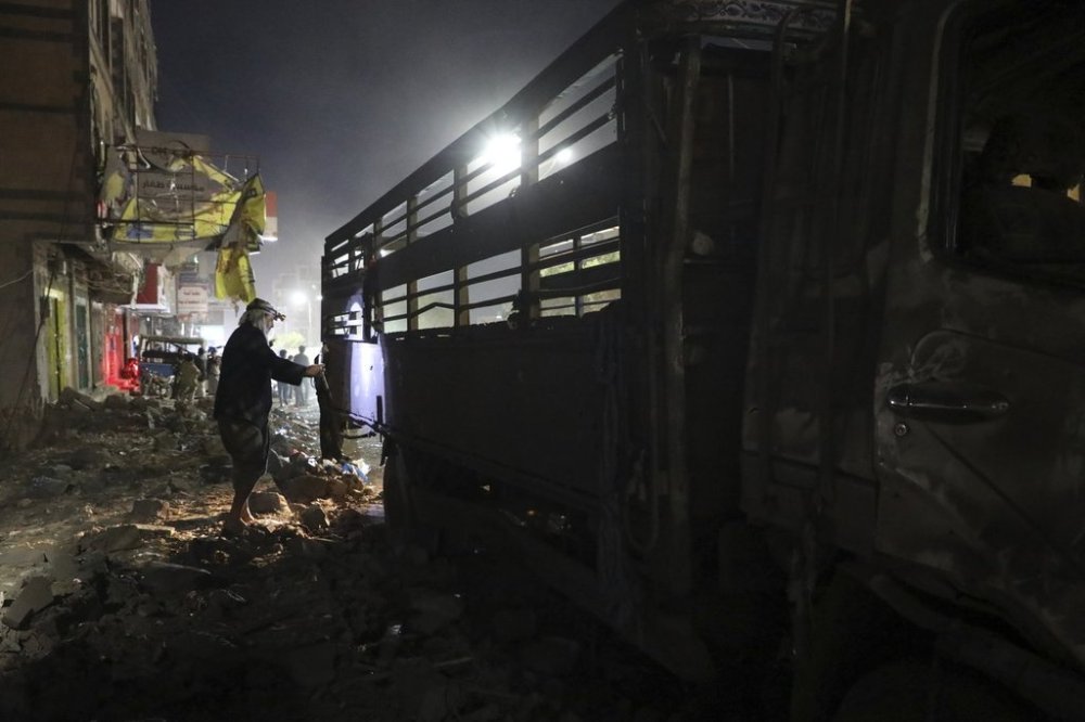 A Yemeni checks his damaged vehicle after U.S. airstrikes in Sanaa, Yemen, Monday, March 24, 2025. (AP Photo)