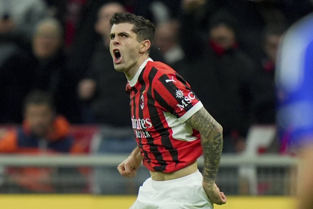 AC Milan's Christian Pulisic celebrates after scoring during the Italian Serie A soccer match between AC Milan and Como at the San Siro Stadium in Milan, Italy, Saturday, March 15, 2025. (Spada/LaPresse via AP)