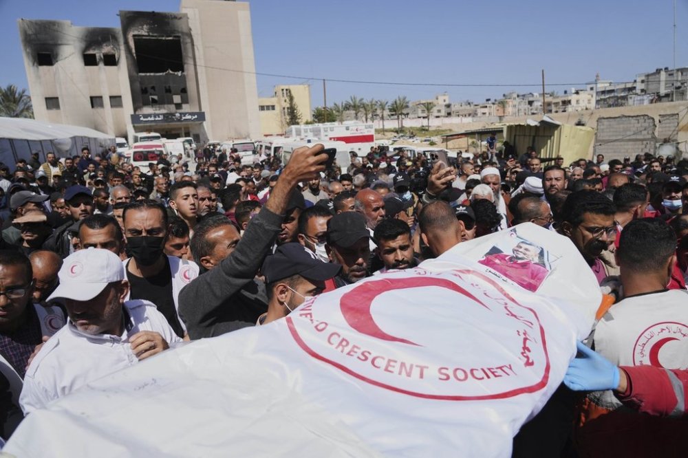 Mourners carry the bodies of 8 Red Crescent emergency responders, recovered in Rafah a week after an Israeli attack, as they are transported for burial from a hospital in Deir al-Balah, Gaza Strip, on Monday, March 31, 2025. (AP Photo/Abdel Kareem Hana)