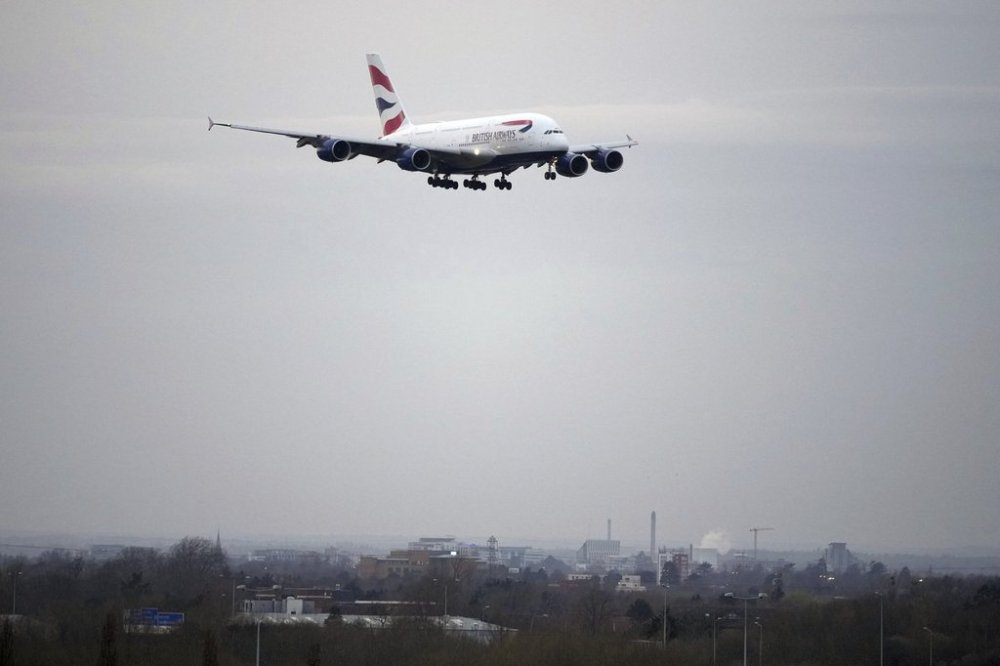 A British Airways plane approaches landing as authorities announced a partial resumption of flights after a fire at a nearby electrical substation has caused a closure of Europe's busiest airport in London, Friday, March 21, 2025.(AP Photo/Kin Cheung)