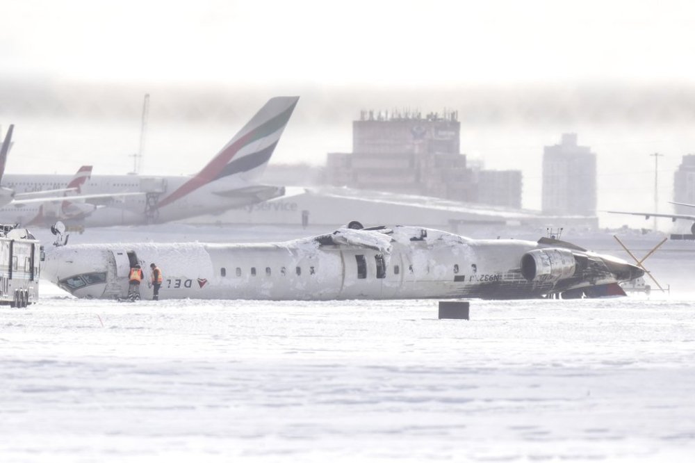 A Delta Air Lines plane lies upside down at Toronto Pearson Airport on Tuesday, Feb. 18, 2025. THE CANADIAN PRESS/Chris Young