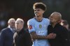 Manchester City's head coach Pep Guardiola, right, celebrates with Manchester City's Nico O'Reilly at the end of the English FA Cup quarterfinal soccer match between Bournemouth and Manchester City at the Vitality stadium in Bournemouth, England, Sunday, March 30, 2025. (AP Photo/Ian Walton)