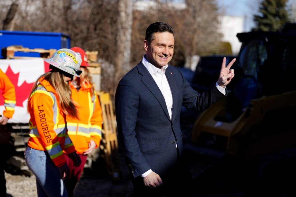 Conservative Leader Pierre Poilievre gestures toward the cameras after greeting and handing out donuts to members at LiUNA! Local 527's training centre on Friday, March 21, 2025. THE CANADIAN PRESS/Justin Tang