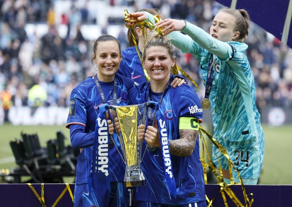 Chelsea's Nathalie Bjorn and Millie Bright lift the trophy following the English women's League Cup soccer final match between Chelsea and Manchester City, at Pride Park Stadium, Derby, England, Saturday March 15, 2025. (Richard Sellers/PA via AP)