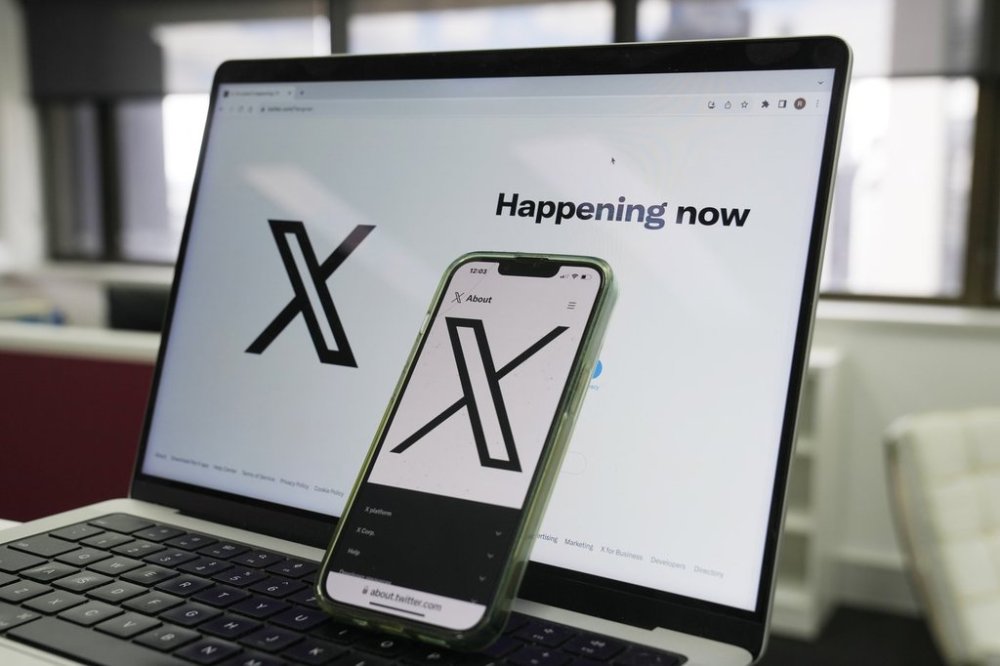 The opening page of X is displayed on a computer and phone in Sydney, Monday, Oct. 16, 2023. THE CANADIAN PRESS/AP-Rick Rycroft