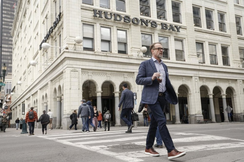 Pedestrians pass the Hudson's Bay building in downtown Calgary, Alta., Thursday, March 20, 2025. THE CANADIAN PRESS/Jeff McIntosh