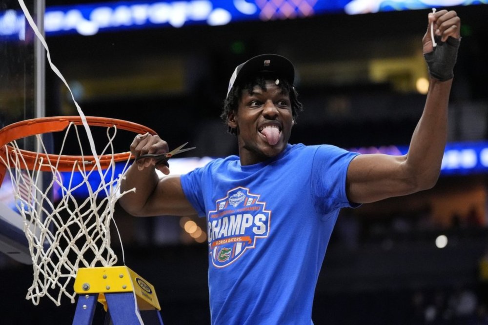 Florida center Rueben Chinyelu (9) cunte part of the net to celebrate victory over Tennessee after an NCAA college basketball game in the final round of the Southeastern Conference tournament, Sunday, March 16, 2025, in Nashville, Tenn. (AP Photo/George Walker IV)