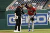 Arizona Diamondbacks' Ketel Marte (4) is checked by a trainer after an apparent leg injury after hitting a double off Washington Nationals pitcher Jake Irvin during the first inning of a baseball game in Washington, Friday, April 4, 2025. (AP Photo/Terrance Williams)