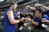 Los Angeles Dodgers pitcher Clayton Kershaw, left, signs autographs for fans before an MLB Japan Series exhibition baseball game against the Hanshin Tigers, Sunday, March 16, 2025, in Tokyo. (AP Photo/Eugene Hoshiko)