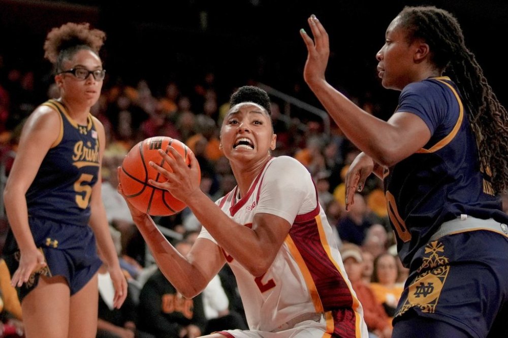 FILE - Southern California guard JuJu Watkins goes to the basket against Notre Dame forward Liatu King as guard Olivia Miles (5) looks on during the second half of an NCAA college basketball game, Saturday, Nov. 23, 2024 in Los Angeles. (AP Photo/Eric Thayer, File)