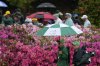 Patrons exit after play was suspend to due weather after a practice round at the Masters golf tournament, Monday, April 7, 2025, in Augusta, Ga. (AP Photo/Ashley Landis)