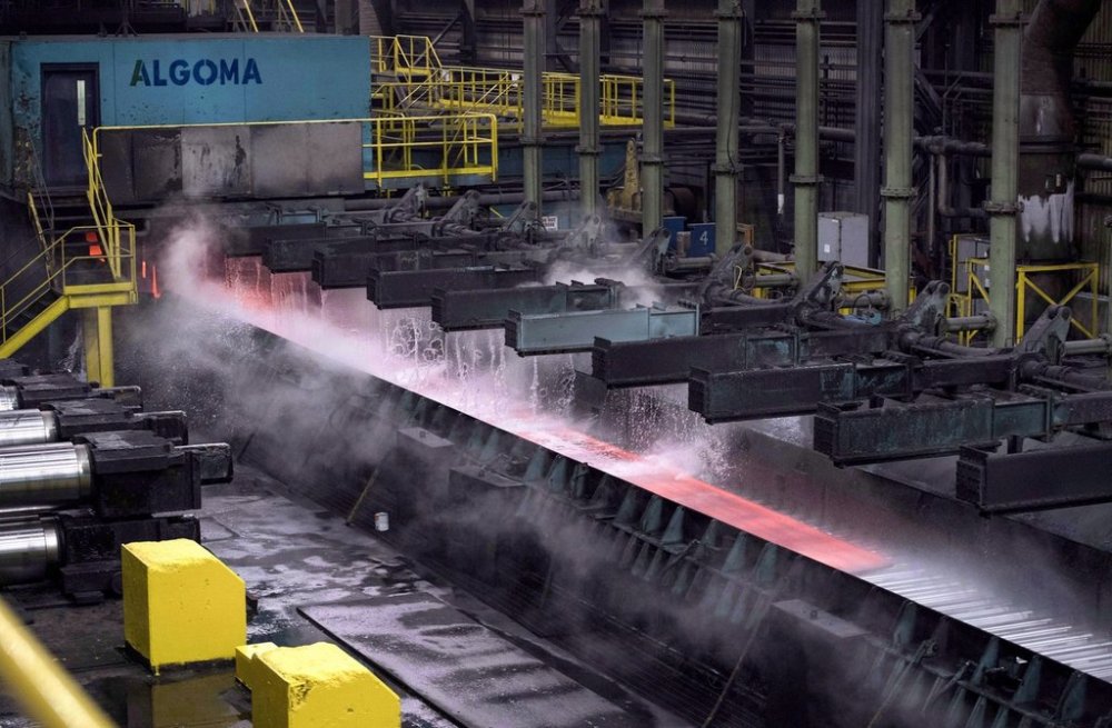 Steam rises as water is poured over hot steel at the Direct Strip Production Complex at Essar Steel Algoma in Sault Ste. Marie, Ont., on Wednesday, March 14, 2018. THE CANADIAN PRESS/Justin Tang