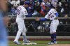 New York Mets' Pete Alonso, left, celebrates his RBI single with first base coach Antoan Richardson during the third inning of a baseball game against the Toronto Blue Jays, Sunday, April 6, 2025, in New York. (AP Photo/Seth Wenig)