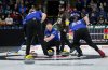 Alberta-Jacobs skip Brad Jacobs, front centre, and Manitoba-Carruthers skip Reid Carruthers, back centre, watch as Alberta-Jacobs second Brett Gallant, left, and lead Ben Hebert sweep during the playoffs at the Brier in Kelowna, B.C., on Saturday, March 8, 2025. THE CANADIAN PRESS/Darryl Dyck