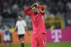 Italy's goalkeeper Gianluigi Donnarumma reacts after the Nations League quarterfinal second leg soccer match between Germany and Italy at the Signal-Iduna Park in Dortmund, Germany, Sunday, March 23, 2025. (AP Photo/Martin Meissner)
