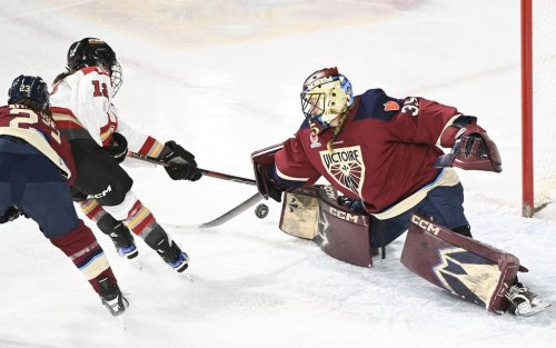 Ottawa Charge's Victoria Bach (12) is stopped by Montreal Victoire goaltender Ann-Renee Desbiens during third period PWHL hockey action in Laval, Que., Wednesday, Jan. 29, 2025. THE CANADIAN PRESS/Graham Hughes