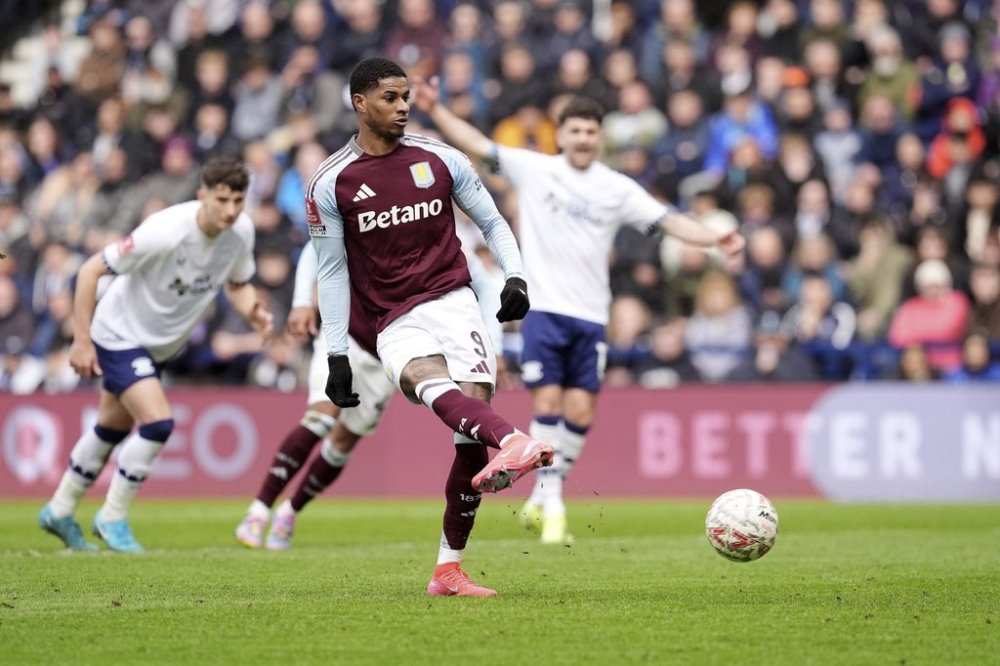 Aston Villa's Marcus Rashford scores their side's second goal of the game from a penalty during the English FA Cup quarter final soccer match against Preston North End at Deepdale, Preston, England, Sunday, March 30, 2025. (Martin Rickett/PA via AP)