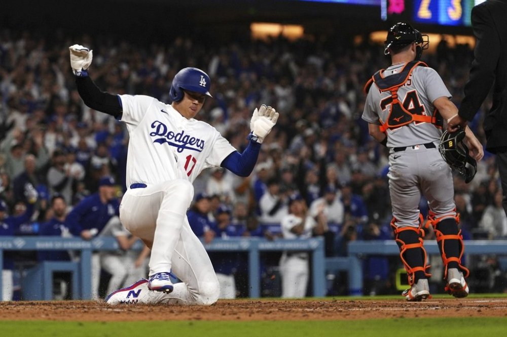 Los Angeles Dodgers' Shohei Ohtani scores on a double by Freddie Freeman as Detroit Tigers catcher Jake Rogers stands by during the seventh inning of a baseball game Saturday, March 29, 2025, in Los Angeles. (AP Photo/Mark J. Terrill)